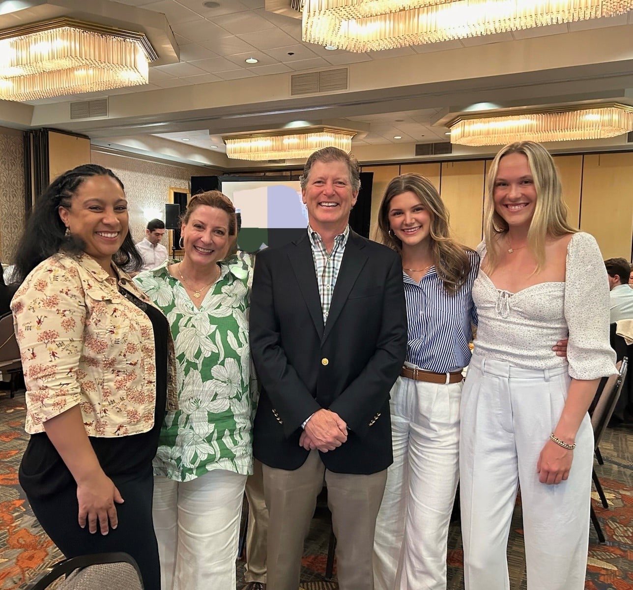 team 2 Dr. Philip Rizzuto with team members at an event.